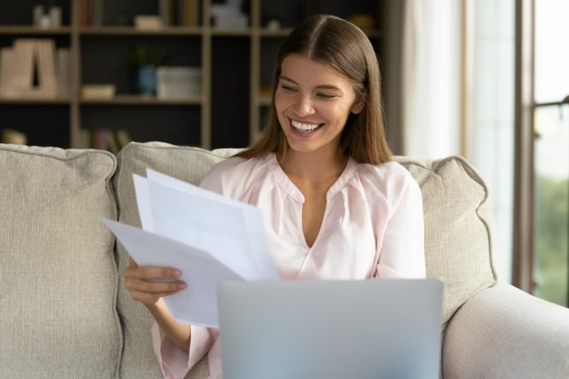 A young woman looking over her documents.