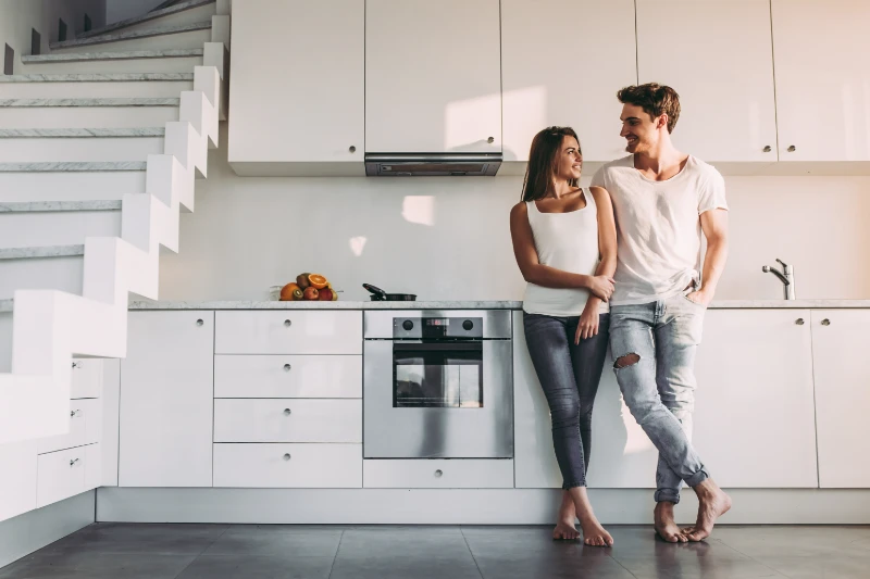 Young couple standing in their new kitchen.